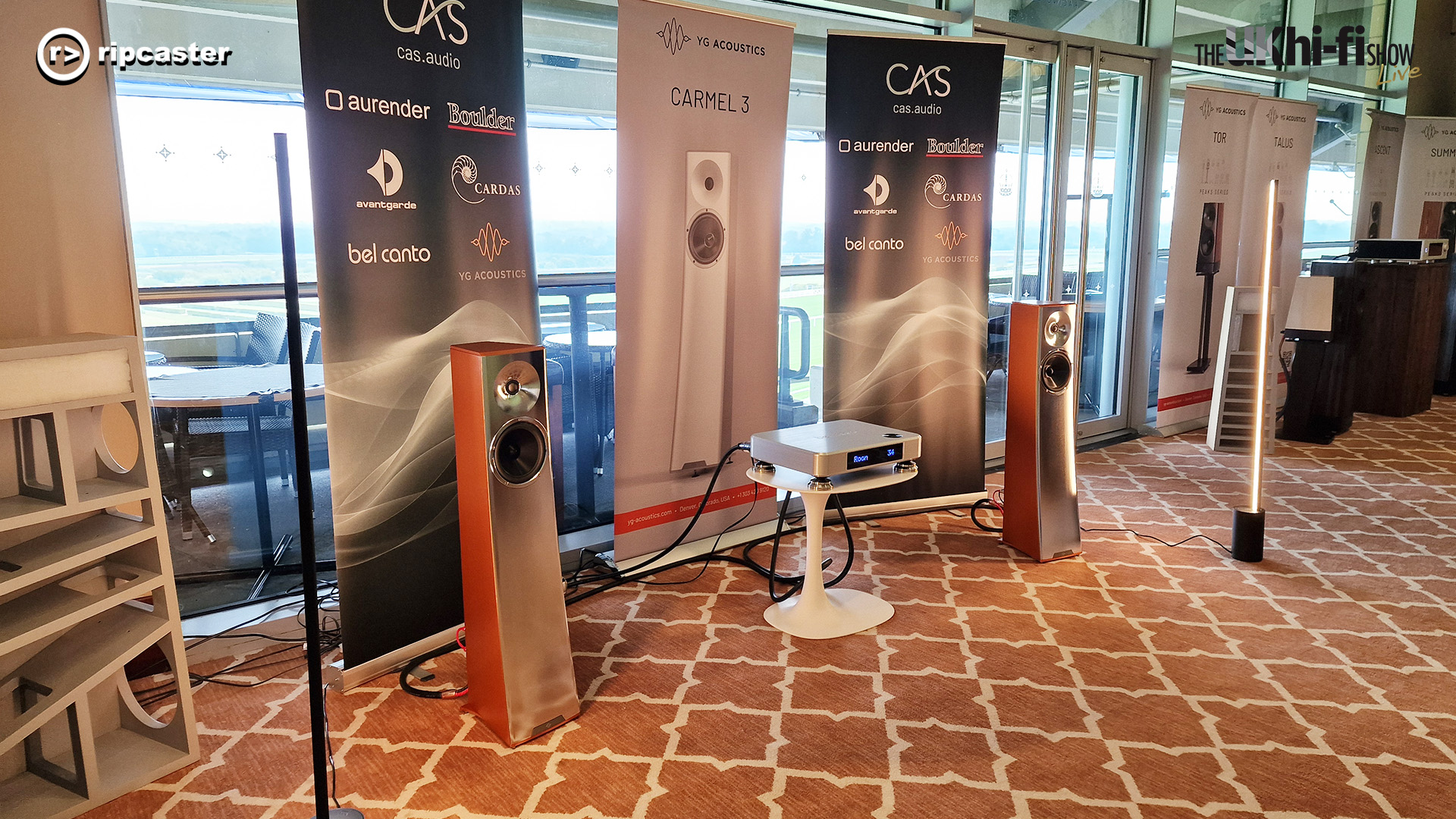 A pair of floorstanding speakers either side of a HiFi unit.  
