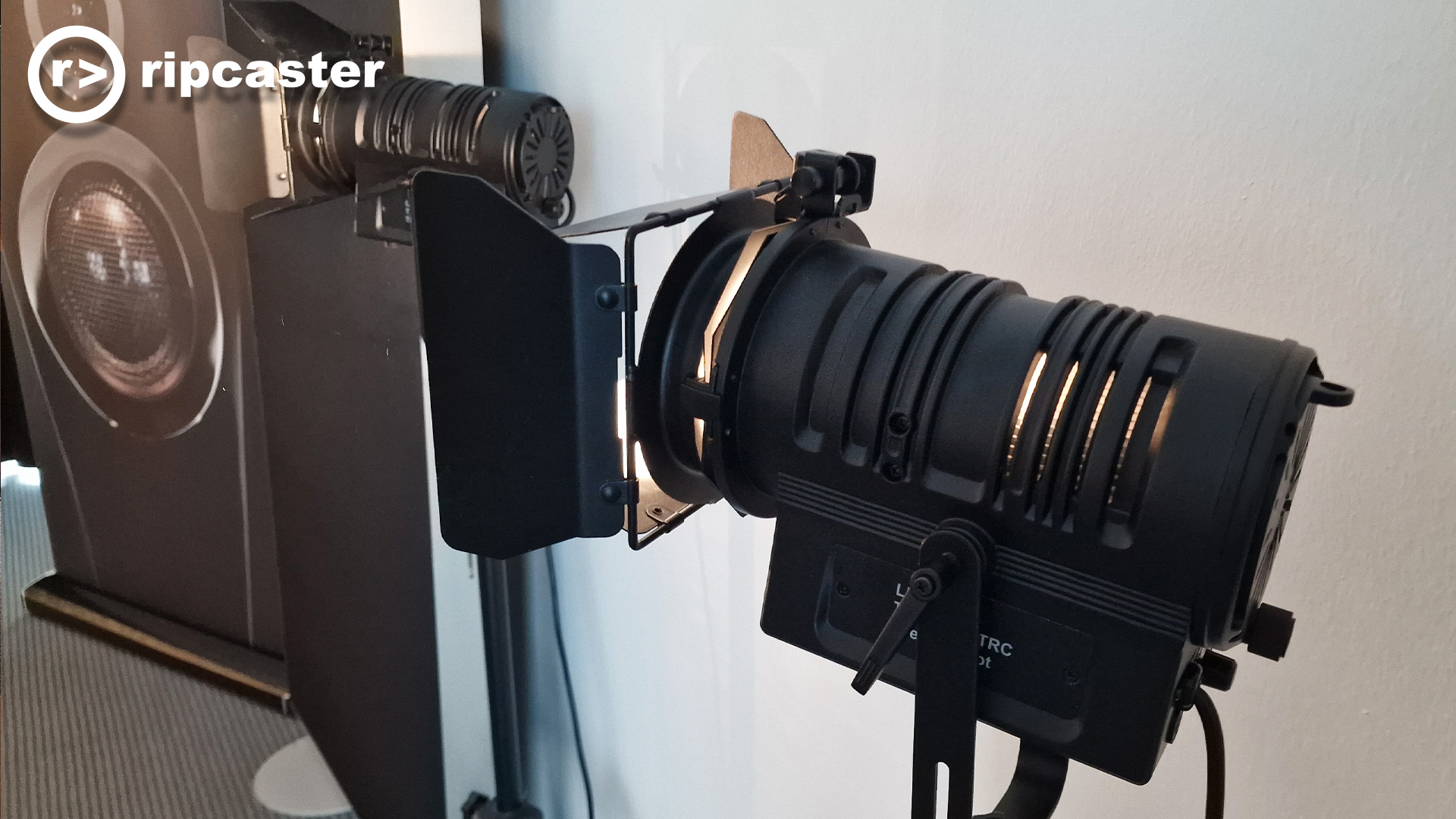 A very fancy looking light on a stand viewed from the side.