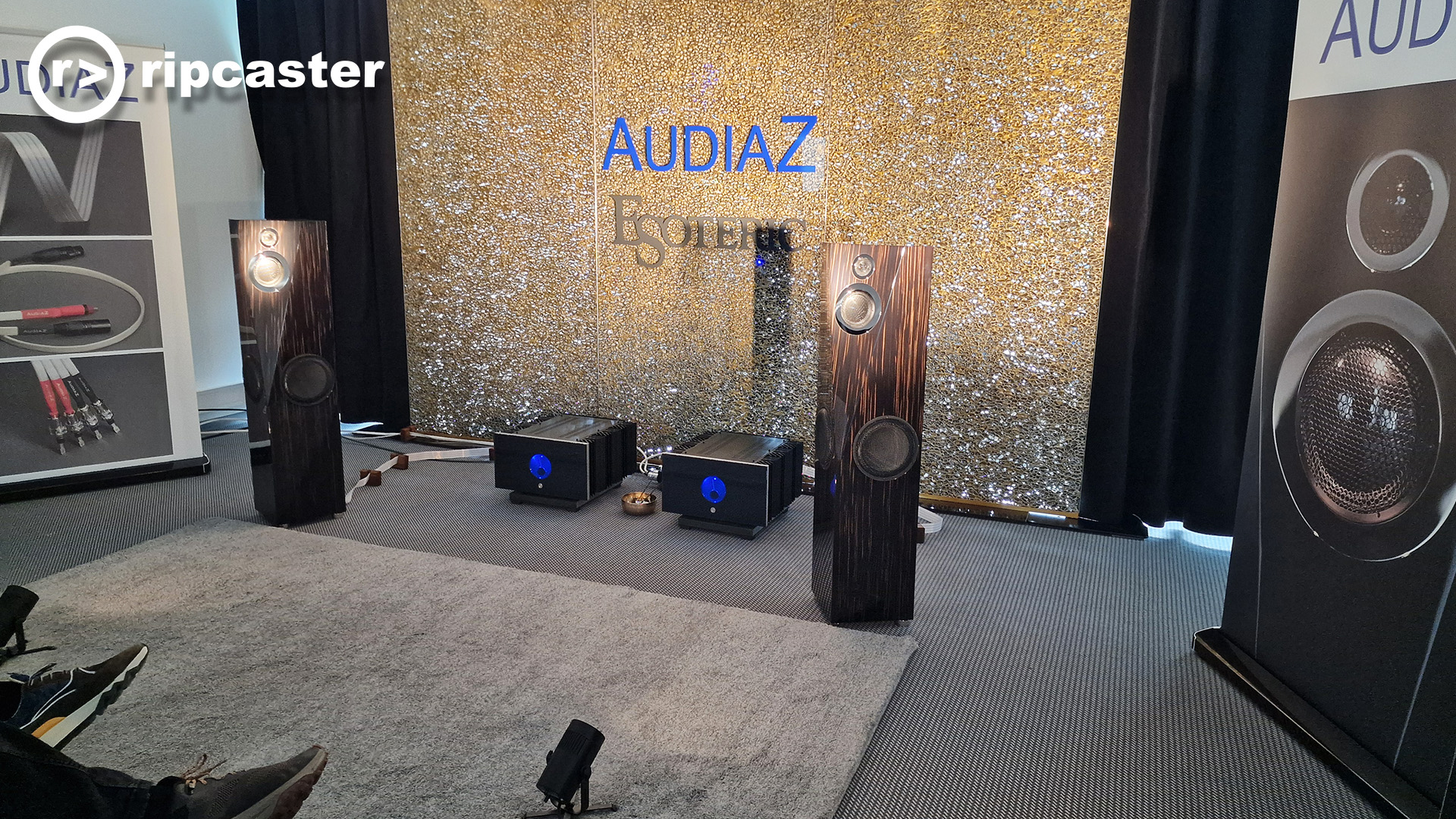A different part of the Audiaz room at the HiFi show in Munich.  There are floorstanding speakers in a wooden finish 
