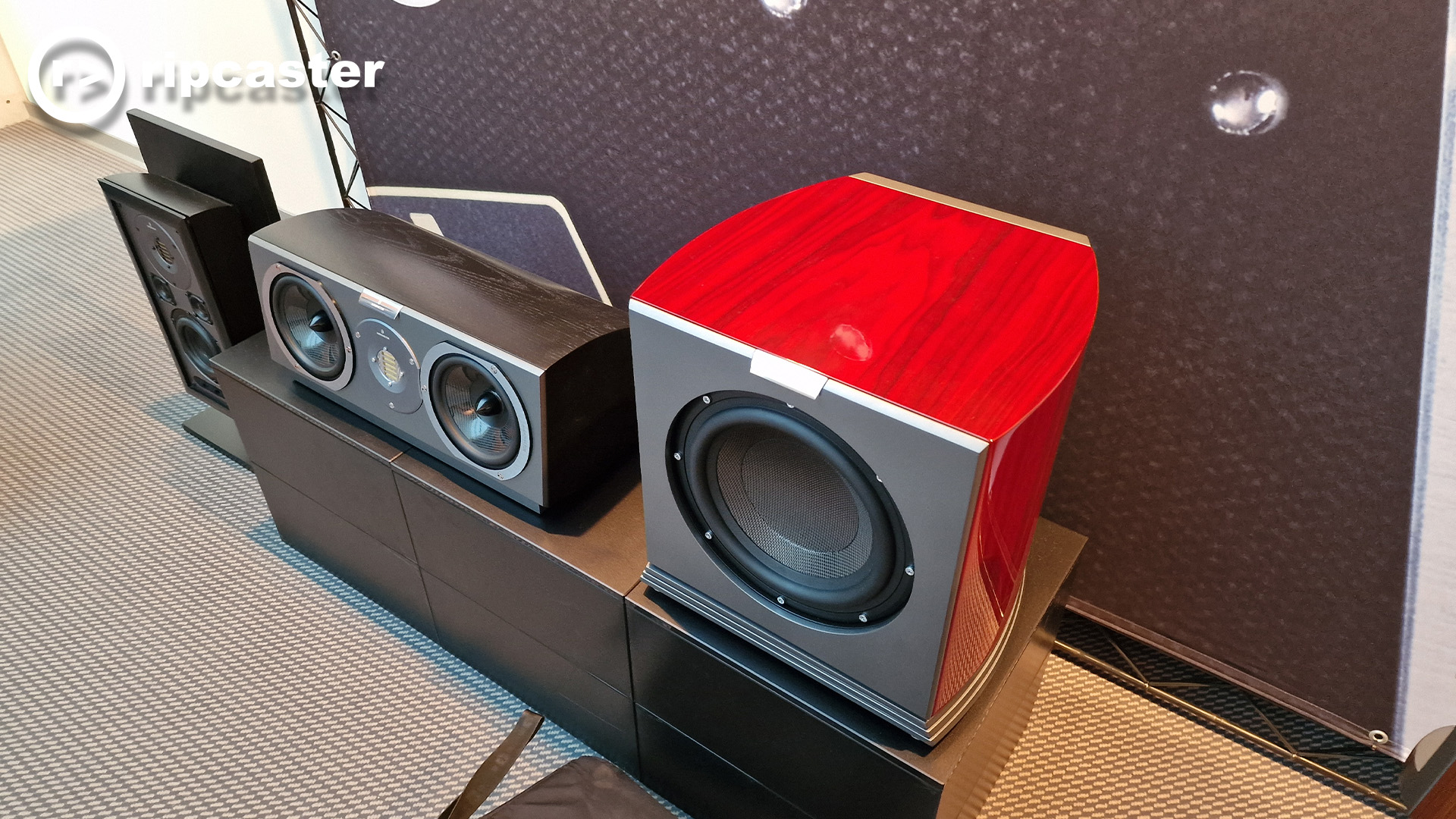 An Audiovector sub beside a small speaker