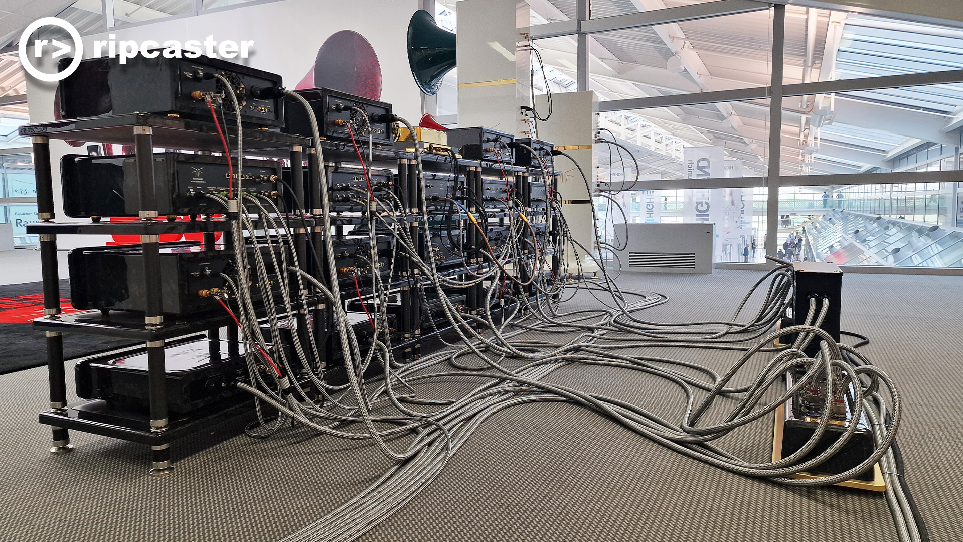 An absolute mass of cables and the HiFi units they are connected to viewed from behind.  