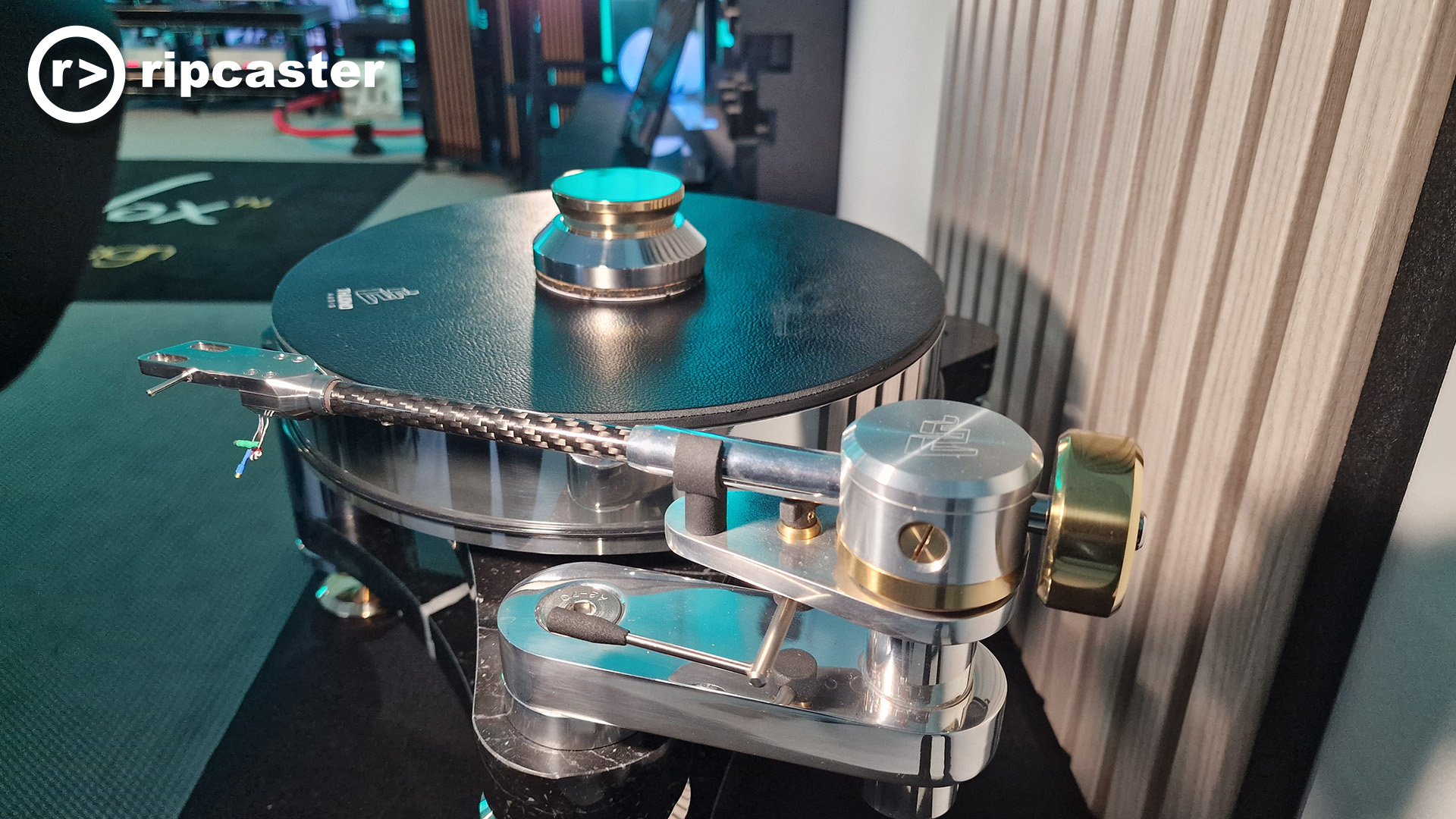 A silver turntable with a silver tonearm