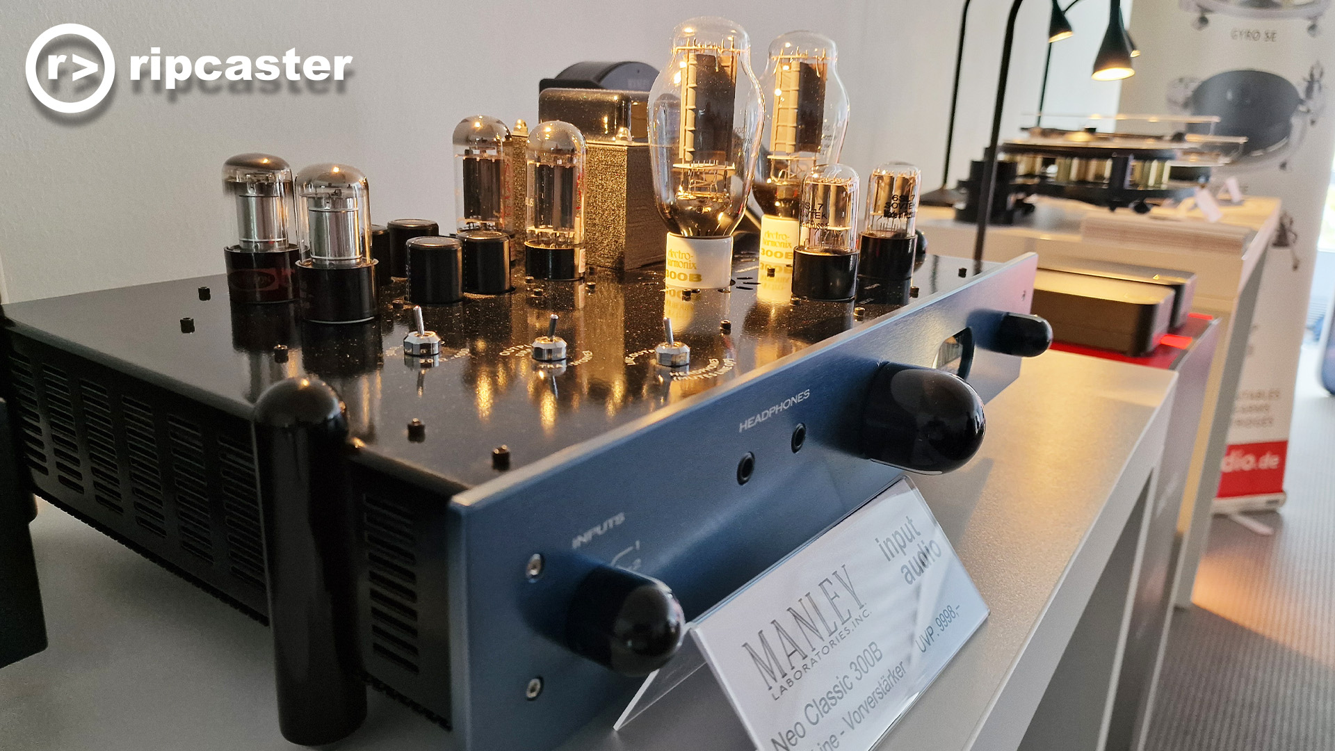 A black rectangular box with lots of valves on the top.  The colouring is black, silver and gold.  This is the Manley stand.