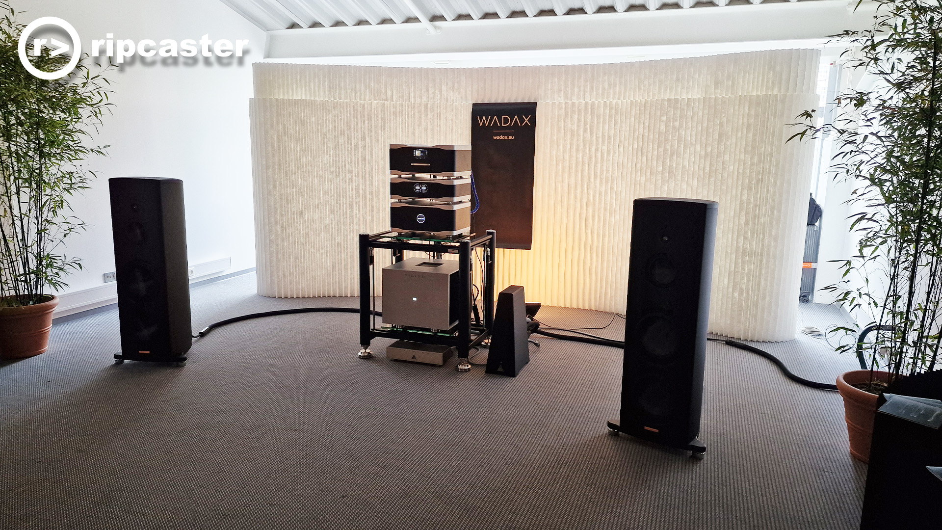 speakers either side of a stack of HiFi units.  This is Wadax.