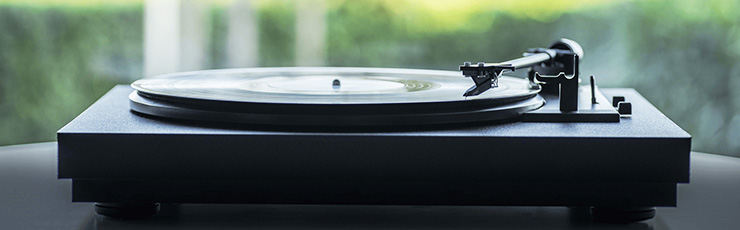 Project AUTOMAT Series A1 turntable on a shelf with trees behind it