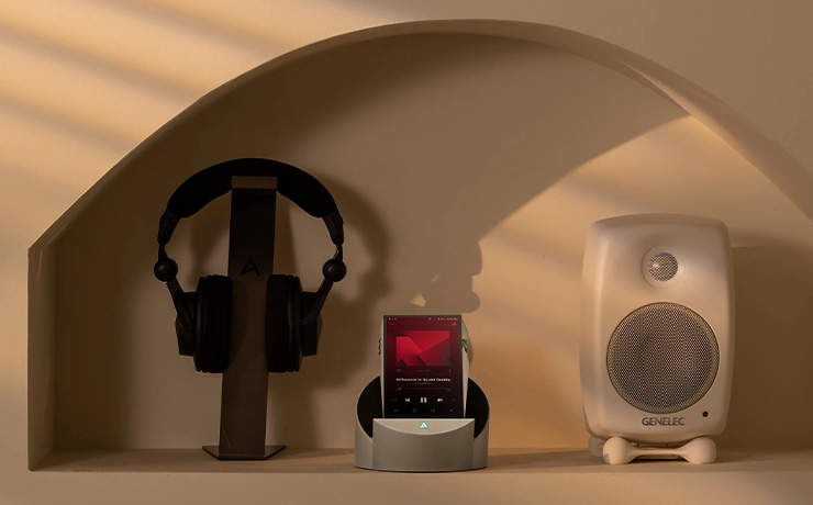 AK Cadle with a portable music player in the cradle with a speaker one side and headphones the other side