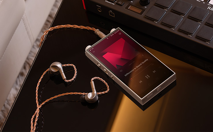 A PD20 laying face-up with earphones plugged in