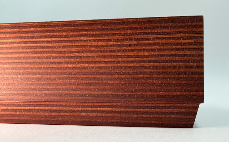 The front right edge of the Bedrok plinth. The plinth has two shades of brown in horizontal thin layers
