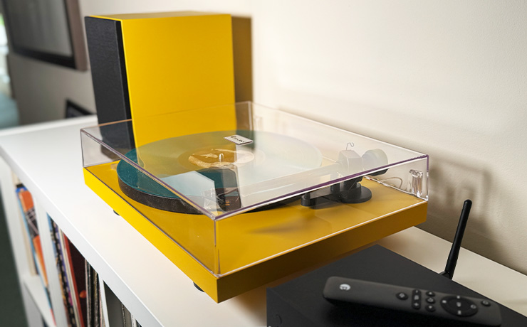 The Project Colourful Audio System in yellow a the ripcaster showroom on top of an Ikea Kallax unit we use to hold some of our vinyl