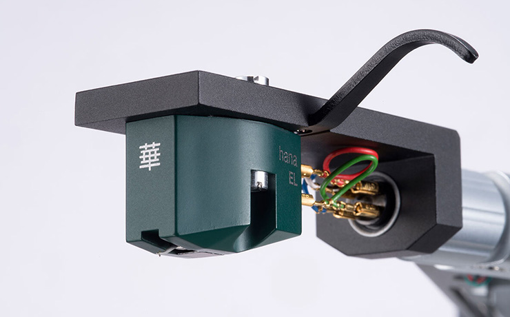 Hana EL cartridge on a tonearm.  The cartridge is a dark green colour