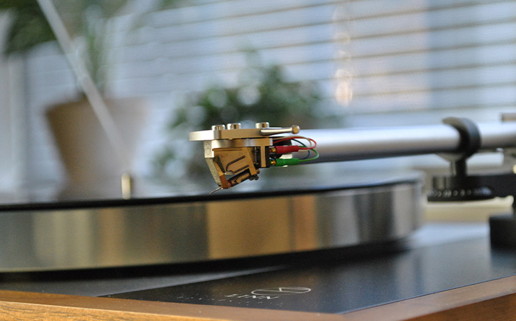 A Linn Kendo cartridge on a turntable. There's a window with blinds in the background