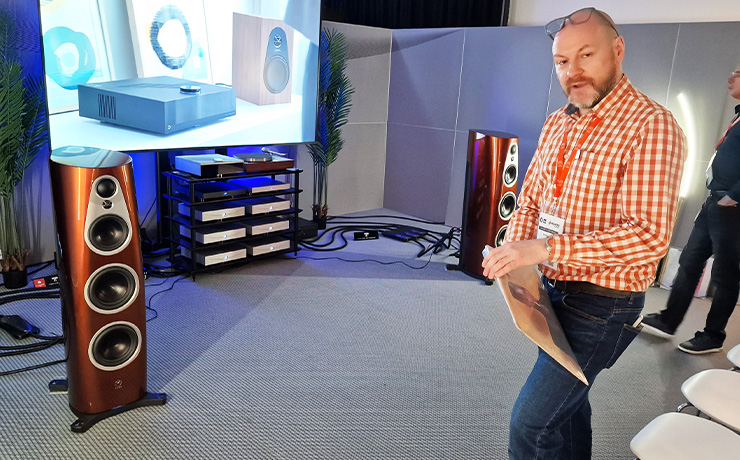 A rack of Klimax Solo 500 amps along with a DSM and an LP12. In the foreground is a pair of 360s and a man taking a record from a sleeve