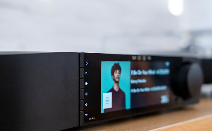The Moon 371 Network Player Amplifier on a wooden surface
