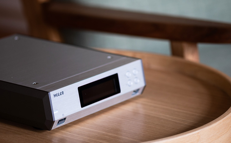 Melco N100 Music Library on a small, wooden circular table