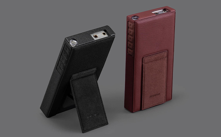 A pair of Astell & Kern PD10 cases.  Both with the PD10 inside - one in black and one in brown