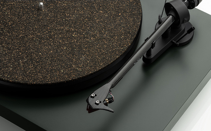A close-up of the tonearm half of the Project Debut Carbon EVO turntable in black satin
