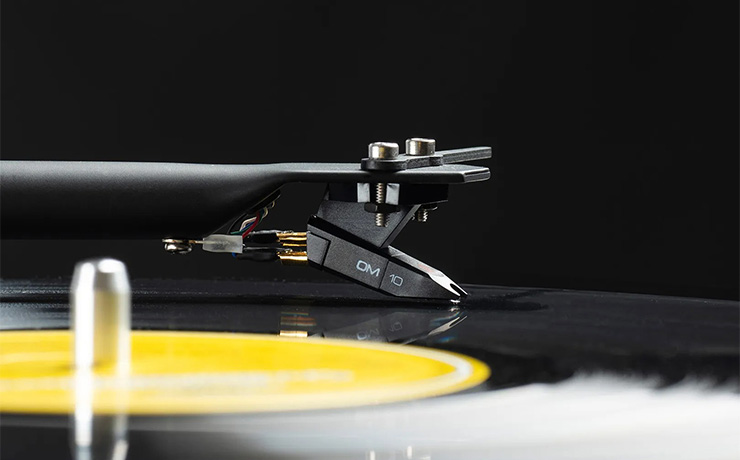 A close-up of a record with the tonearm and cartridge in close-up