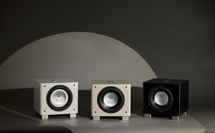 three REL T/9x subs. One white, one grey and one black