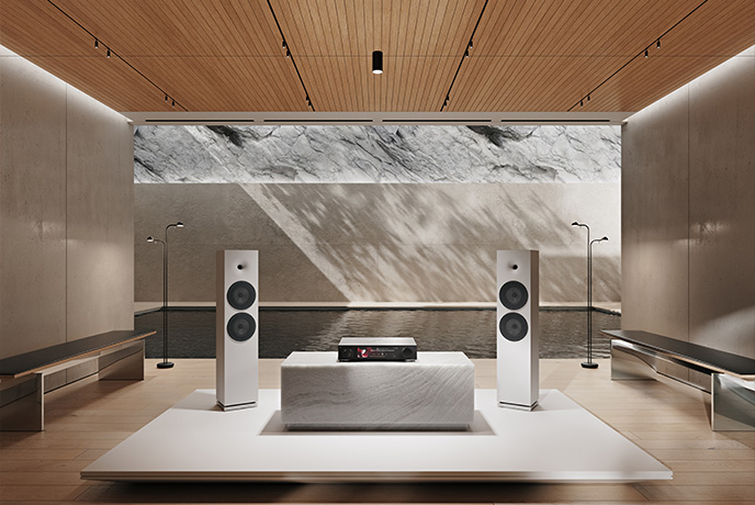 The HiFi Rose RS451 in silver on a low unit in between two floorstanding speakers
