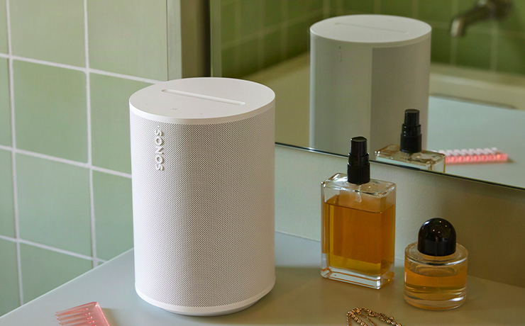 A Sonos Era 100 SL speaker in white on a bathroom surface