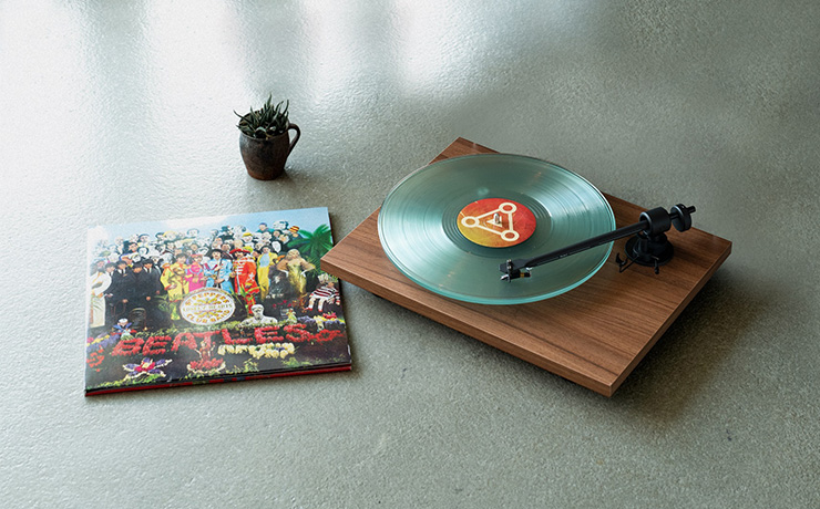 Project T1 Turntable on the table with a Beatles vinyl sleeve beside it