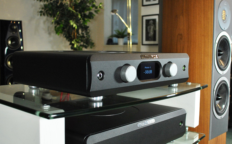 The Ultrafide U4PRE on the top shelf of a HiFi rack with a U500DC on the shelf below and an Audiovector floorstanding speaker beside it