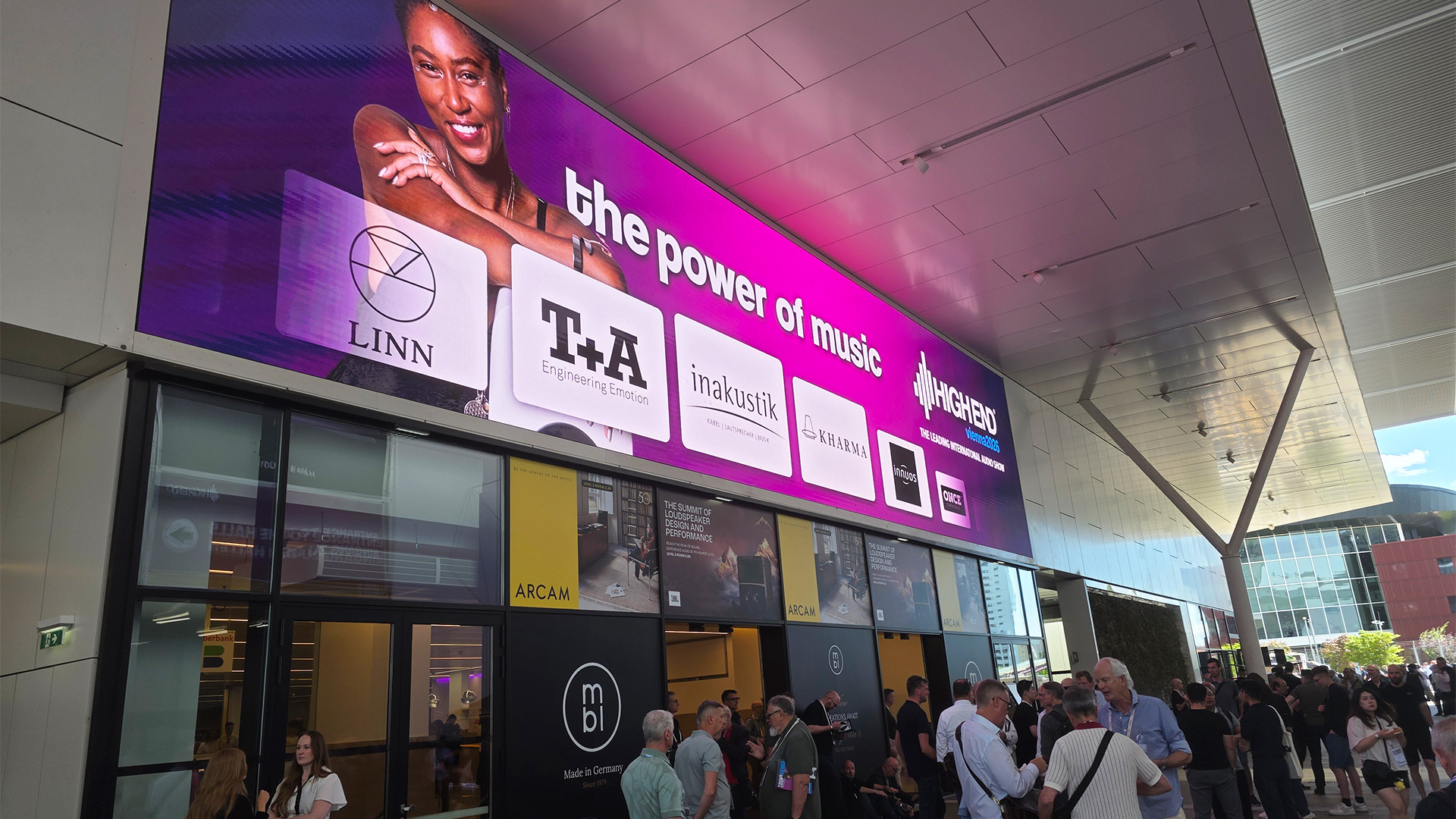 The entrance to the HiFi show with a lit up sign and people milling about