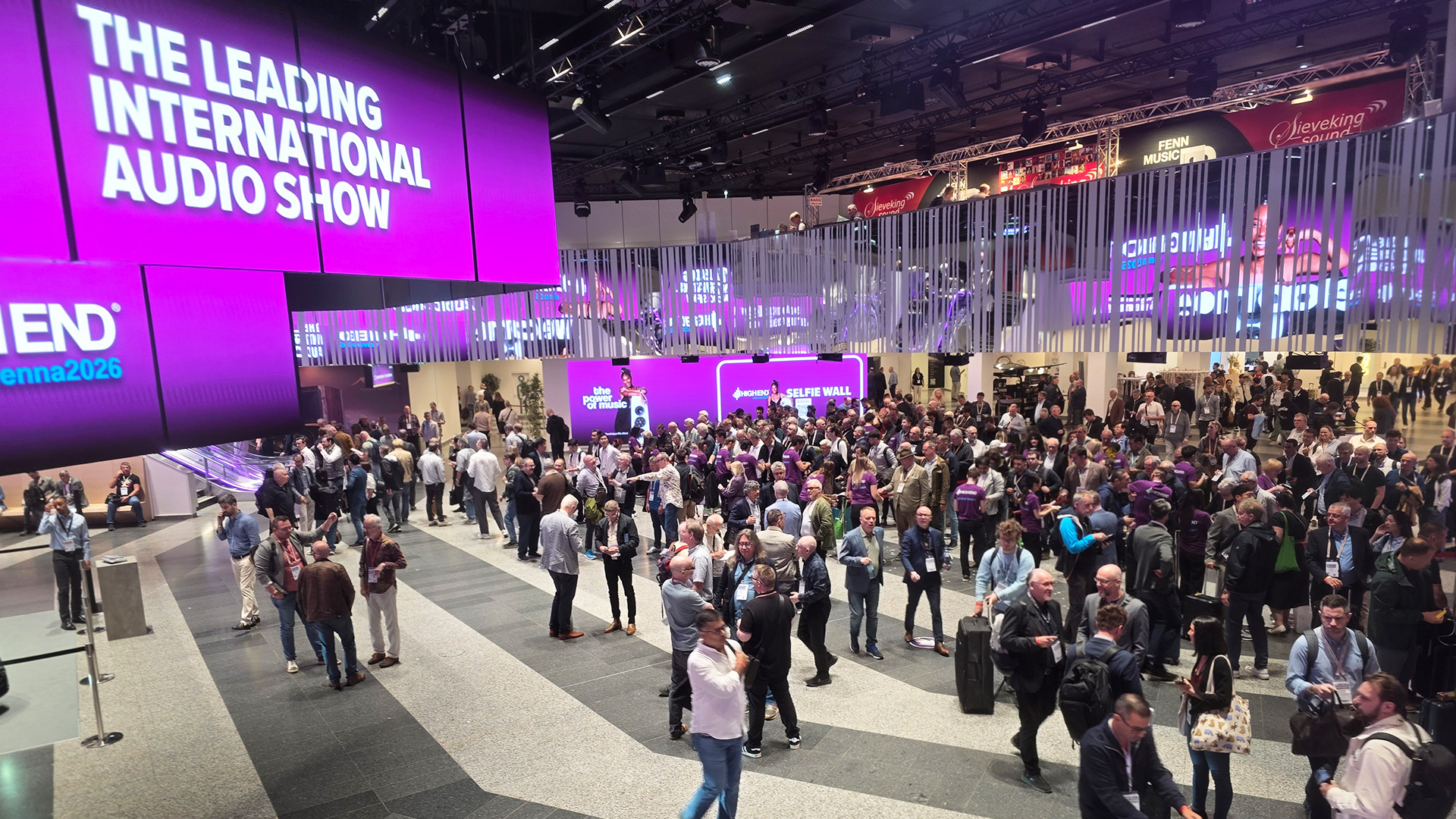 The Vienna HiFi Show with a large sign and many people 