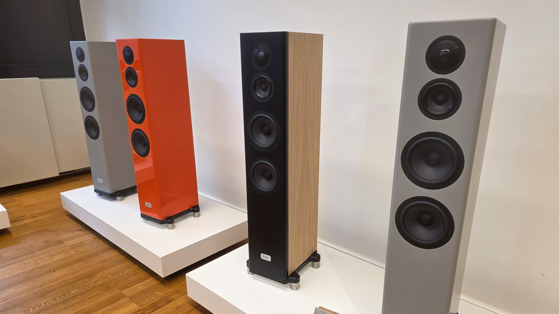 Four speakers in different finishes at the HiFi show