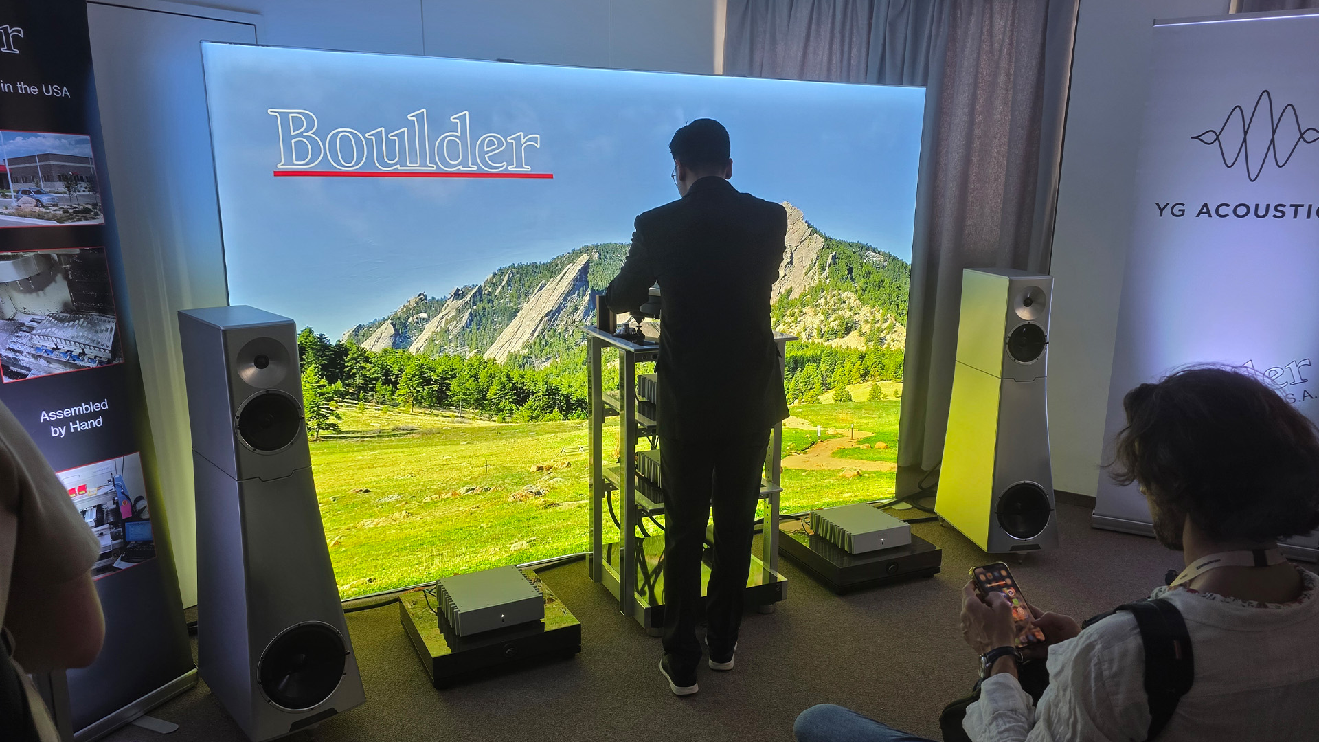 A room at the Vienna HiFi show with a man standing in front of the HiFi stack of equipment