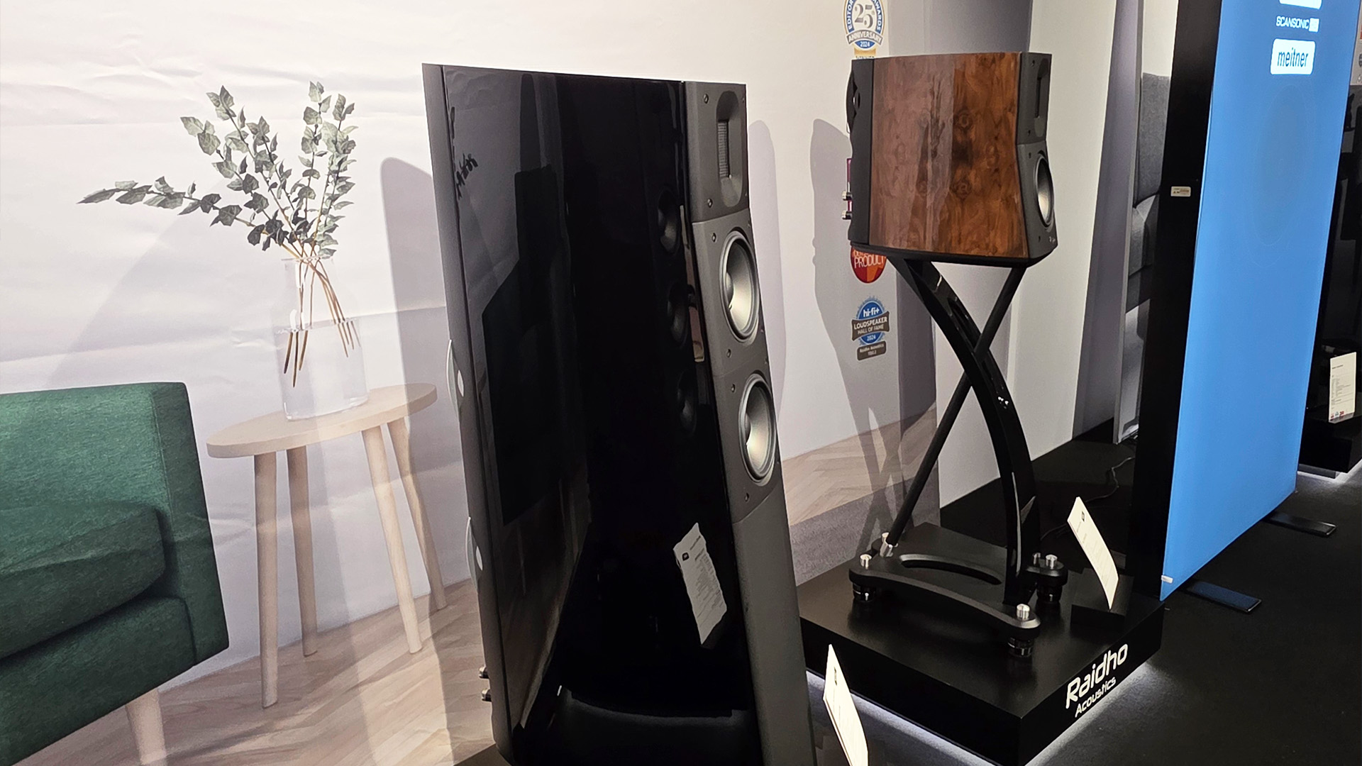 A pair of Raidho speakers, one floorstanding, one bookshelf on a stand