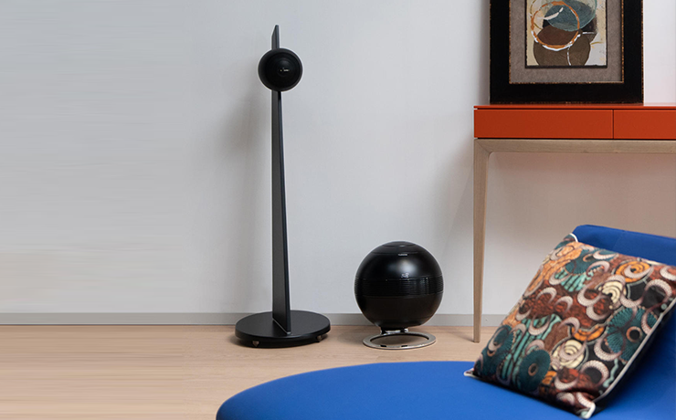 A Cabasse black iO3 speaker on stand beside a sub